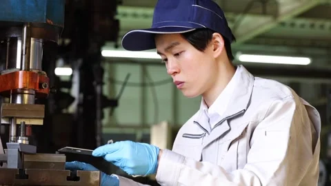 Japanese Factory Worker Inspecting Precision Pressed Metal Part Stock-Footage 344210622