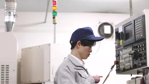 Japanese Factory Worker Operating CNC Machine Control Panel Stock-Footage 344212410
