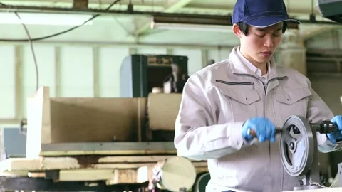 Japanese Factory Worker Operating Drill Press for Precision Metalworking Stock-Footage 344210510