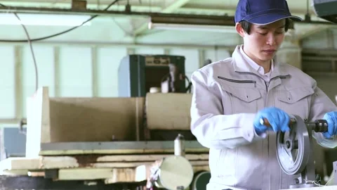 Japanese Factory Worker Operating Drill Press for Precision Metalworking Stock-Footage 344210623