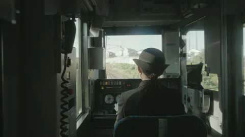 Japanese female train driver using point-and-calling method, shot in Stock Footage 159418391