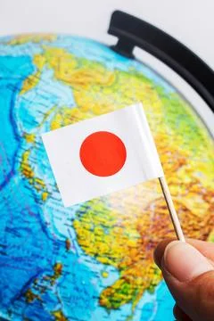 Japanese flag on background of globe with map Stock Photos