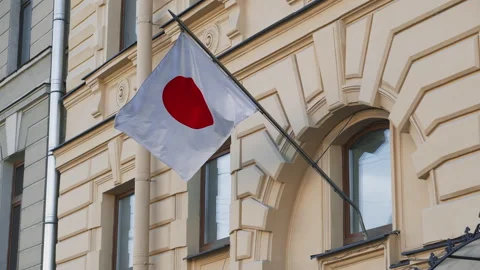 The Japanese flag is developing against the background of an old yellow Stock Footage 131974038