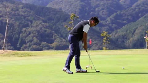 Japanese Golfer Practicing Putting Before a Round on Golf Course 스톡 동영상 344131403