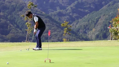 Japanese Golfer Practicing Putting Before a Round on Golf Course 스톡 동영상 344132421