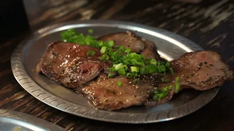 Japanese grill beef tongue slice on plate with lemon in Izakaya restaurant style Stock Footage
