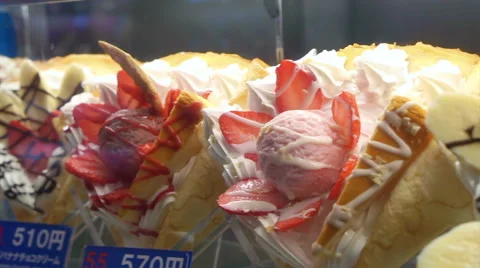 Japanese Harajuku style crepe. Dessert decorate with fruits, cream and ice cream Stock Footage