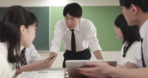 Japanese junior-high school students studying with teacher in the classroom Video stock 163001659