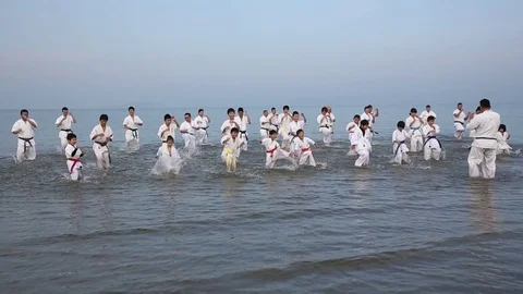 Japanese karate martial arts running at the beach Stock Footage