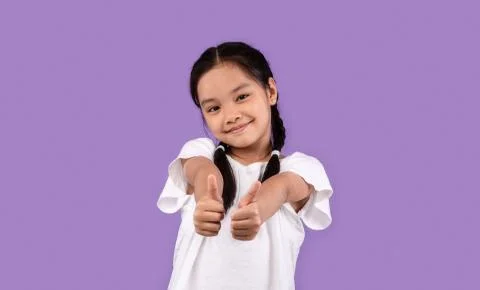 Japanese Kid Girl Gesturing Thumbs Up Standing Over Purple Background Stock Photos