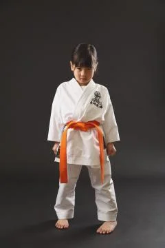 Japanese kid in karate uniform on black background Stock Photos