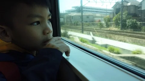 Japanese Kid is looking out of the train to the outside world Stock Footage 110897591