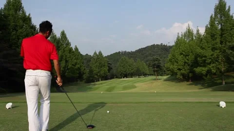 Japanese male golf player hitting tee shot Stock Footage