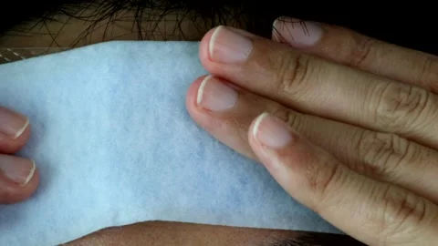 Japanese man applying a cooling sheet to his forehead Stock Footage 327885261