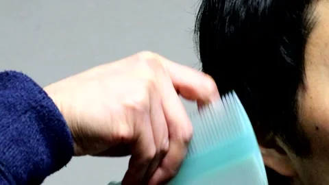 Japanese man combing his hair Stock Footage 336175953