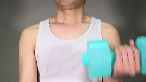 Japanese man doing dumbbell exercises Stock Footage 336673840