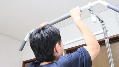 Japanese man doing pull-ups Stock Footage 336630195