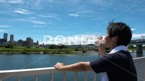 JAPANESE MAN drinking water. Stock Photos
