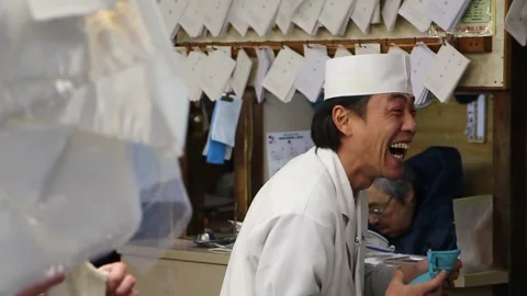 Japanese man laughing at work market white uniform Video stock 145731353