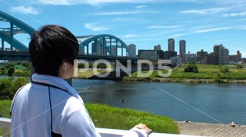 JAPANESE MAN looking at the river and thinking. Stock Photos
