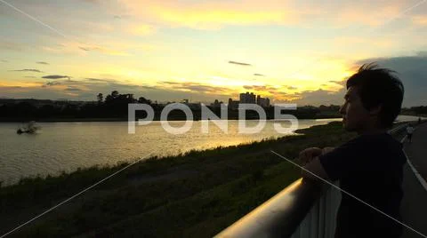 JAPANESE MAN looking at the river and thinking. Stock Photos