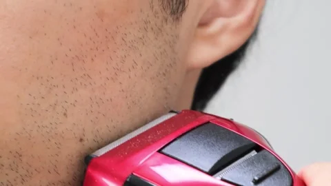 Japanese man shaving his beard with an electric razo Stock Footage 336567997