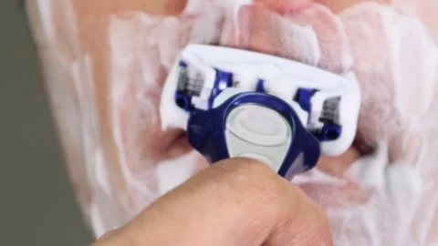 Japanese man shaving his beard Stock Footage 336580153