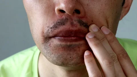 A Japanese man touching his beard and posing Stock Footage 329335534