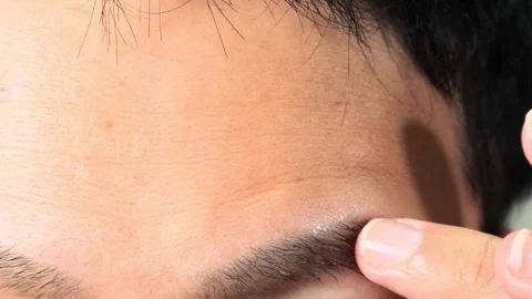 Japanese man touching his eyebrows Video stock 336637491