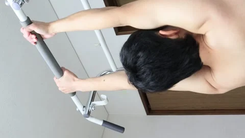 Japanese man training on a pull-up bar. Video stock 336628059