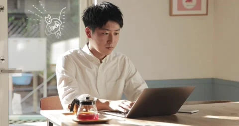 Japanese man using laptop at a cafe Stock Footage 152197162