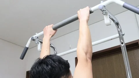 Japanese man using a pull-up bar Stock Footage 336629354