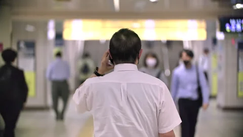 Japanese man using smartphone to make call in underground subway station during  Stock-Footage 244057665