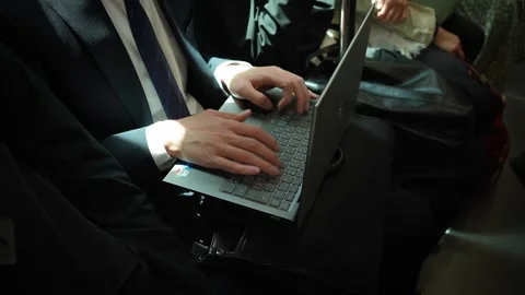 Japanese man working on laptop inside Tokyo train carriage Stock Footage 314677581