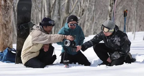 Japanese men having coffee on snow in the backcountry Stock Footage 244633599