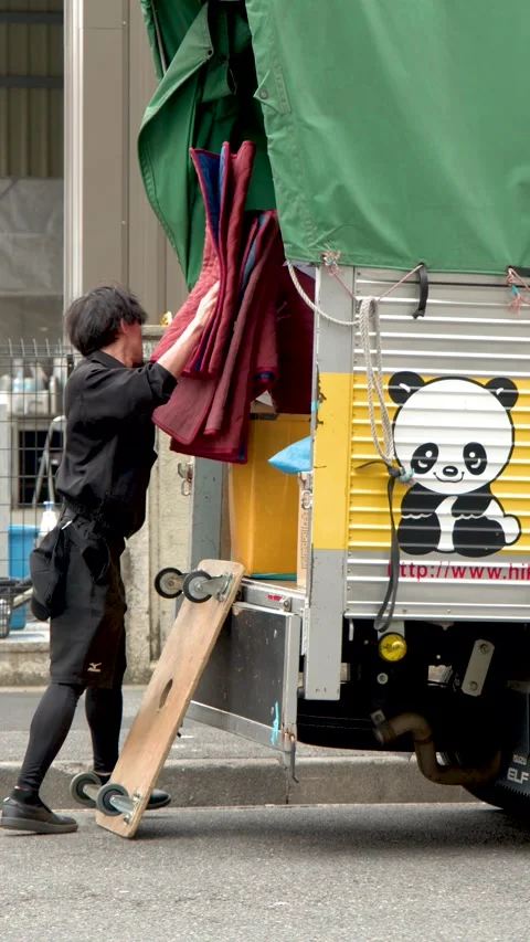 Japanese Moving Service Worker Unloading Equipment From Delivery Truck Stock Footage 342468734
