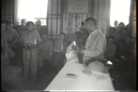 Japanese representatives at table bring a large map and point on the map - 1945 Stock Footage 93844278