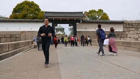Japanese runner jogging in Osaka Castle, Japan Stock Footage 90643634
