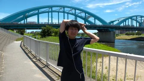 JAPANESE RUNNER MAN doing some stretches. Stock Photos