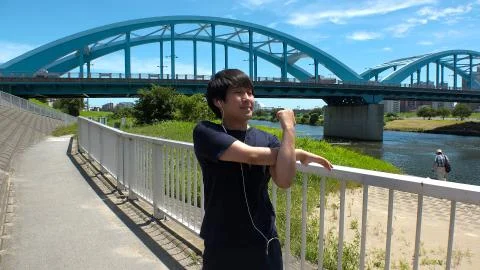 JAPANESE RUNNER MAN doing some stretches. Stock Photos