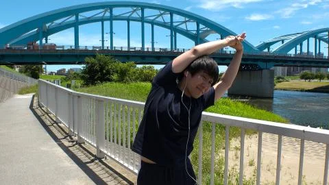 JAPANESE RUNNER MAN doing some stretches. Stock Photos