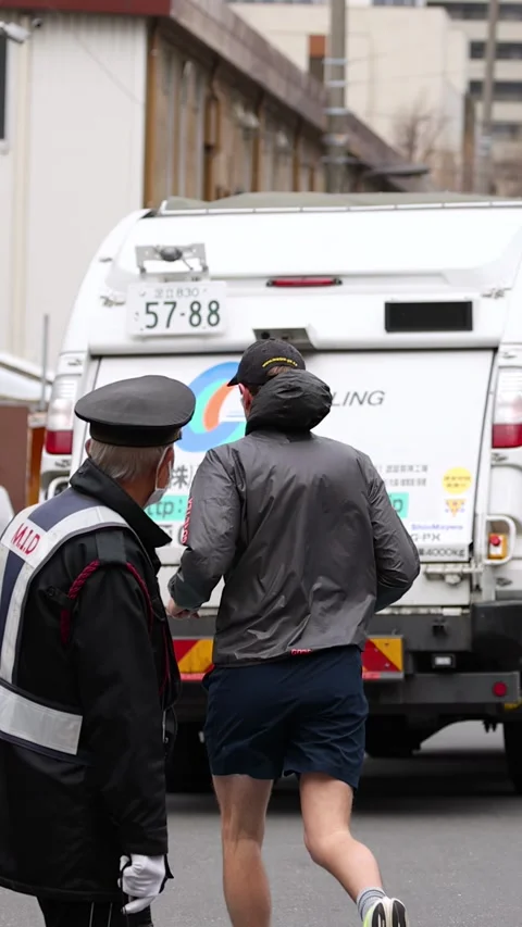Japanese Sanitation Worker and Security Guard on Busy Tokyo Street Stock Footage 343593582