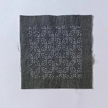 Japanese Sashiko Stitching Pattern on Gray Fabric.  Stock Photos