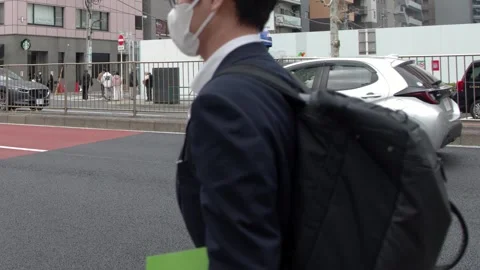 Japanese Security Guard Directing Traffic on a Busy Tokyo Street Stock Footage 334919430