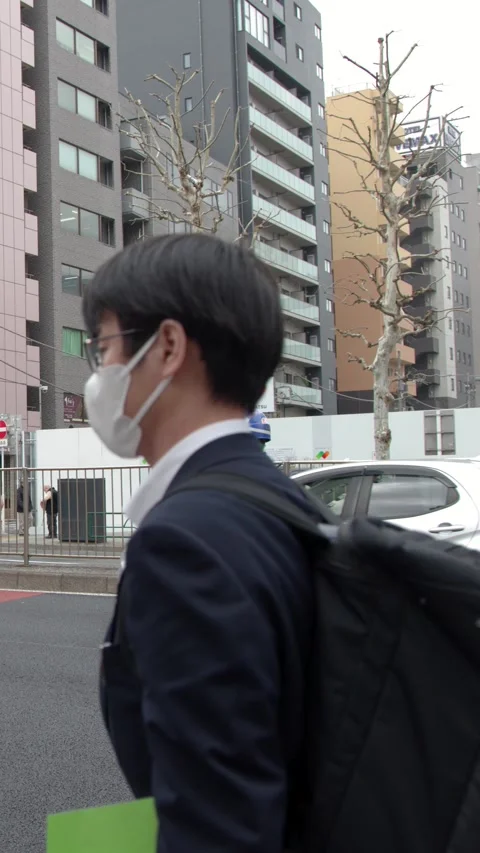 Japanese Security Guard Directing Traffic on a Busy Tokyo Street Stock Footage 336519593