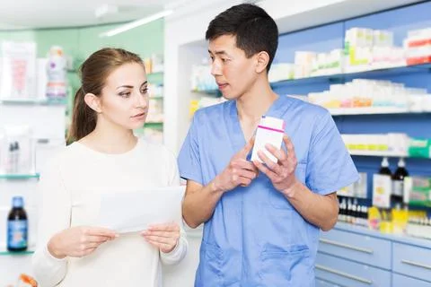 Japanese specialist helping client choose medicine Stock Photos