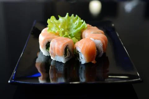 Japanese sushi on a black plate. Stock Photos