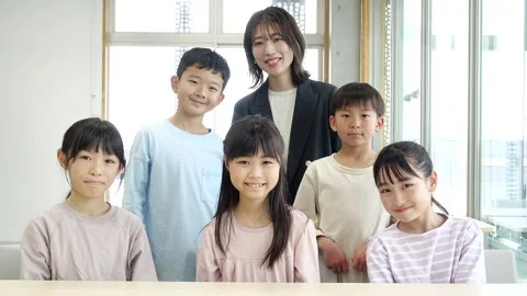 Japanese Teacher and Elementary School Students Smiling in Classroom Vídeos de archivo 344096989