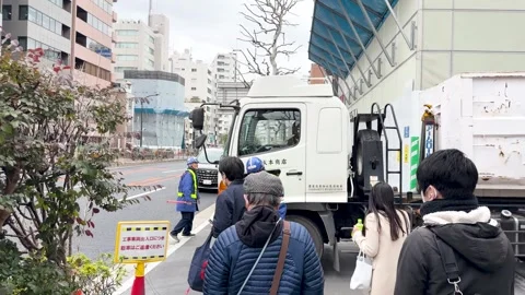 Japanese Traffic Controller Directing a Large White Stock Footage 335808535