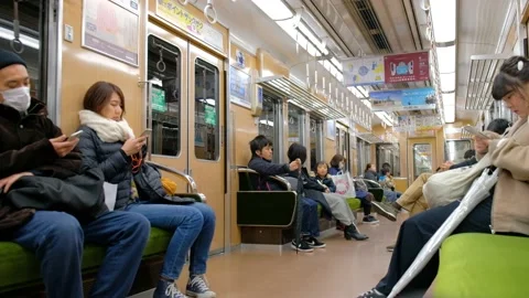 Japanese train passengers using smart phones. Stock Footage 133212611